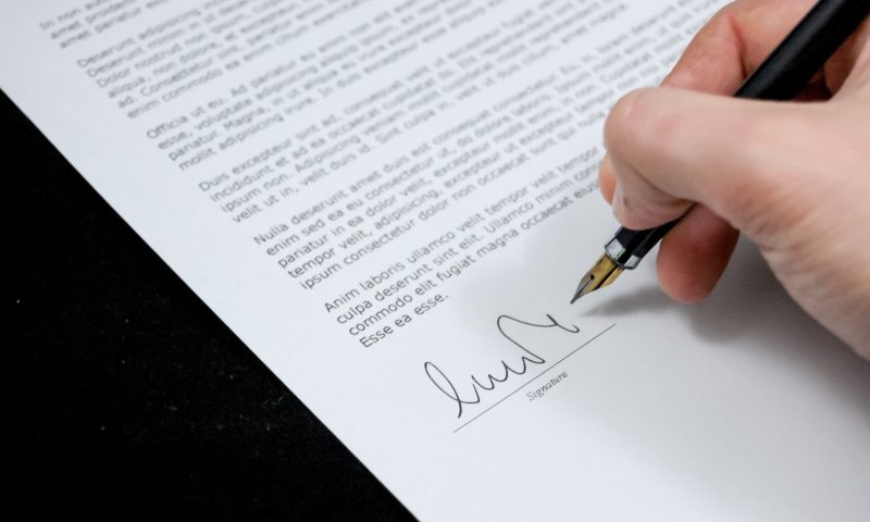 person signing employment contract